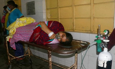 A patient receives oxygen lying on a stretcher at the Medical College Hospital in Rajshahi, Bangladesh (Photo | AP)