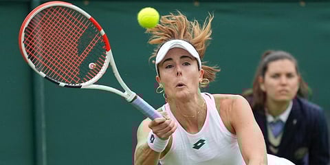 Alize Cornet plays a return to Bianca Andreescu during the women's singles first round match on day three of the Wimbledon in London. (Photo | AP)