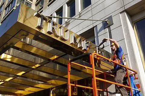 In this Wednesday, Nov. 16, 2016 file photo, a worker removes letters from the awning of a building formerly known as Trump Place in New York. (Photo | AP)