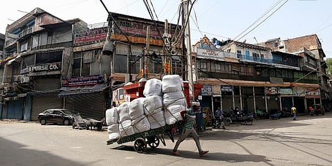 A worker pulls handcart during the lockdown imposed amid the rise in COVID-19 cases in New Delhi. (Photo| ANI)