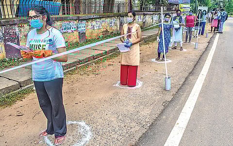 Candidates waiting in queue to enter a NEET examination centre. (Photo | Biswanath Swain)