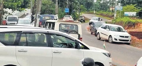 Vehicles of BJP leaders parked outside Saraswathi Vidyalaya in Kadaba on Sunday. (Photo | EPS)