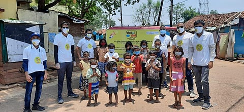 A group of children in a slum locality with the volunteers of of the campaign. (Photo | Express)