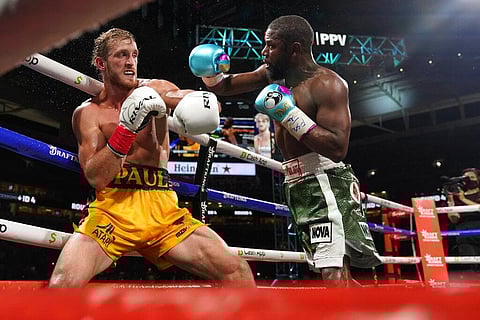 Floyd Mayweather, right, throws a punch at Logan Paul, left, during an exhibition boxing match at Hard Rock Stadium. (Photo | AP)