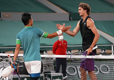 Germany's Alexander Zverev, right, shakes hands with Japan's Kei Nishikori, after he defeated him in their fourth round match on day 8, of the French Open. (Photo | AP)