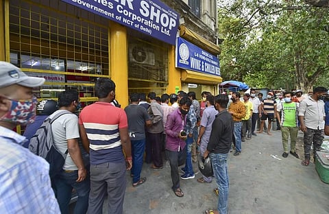 Long queue outside a wine shop after unlocking of COVID-19 lockdown begins, at Gole market in New Delhi, Monday, June 7, 2021. (Photo | PTI)