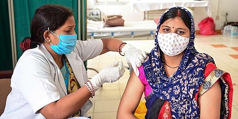 A beneficiary receives a dose of COVID-19 vaccine at a railway station in Prayagraj. (Photo | PTI)