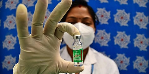 A health official displays a Covishield vaccine. (Photo | Shriram BN, EPS)