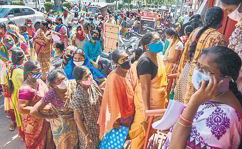 Jagananna Thodu beneficiaries throng Krishna District Cooperative bank in Vijayawada on Tuesday to get verified for the scheme I Prasant Madugula