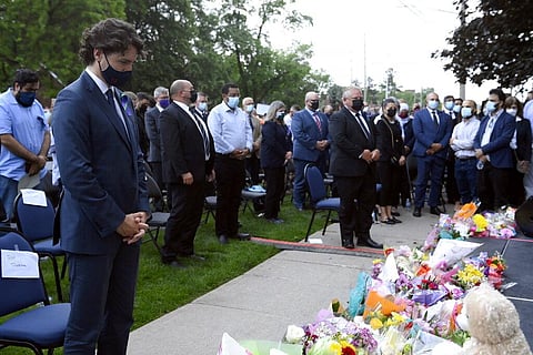 Prime Minister Justin Trudeau, left, and Ontario Premier Doug Ford, fourth from right, look on during a moment of silence at a vigil for the victims of the deadly vehicle attack. (Photo | AP)