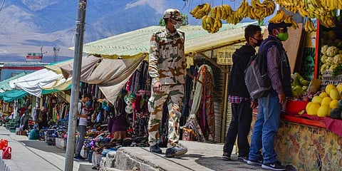 An ITBP official patrols at a local market during Unlock 2.0 in Leh. (Photo | PTI)