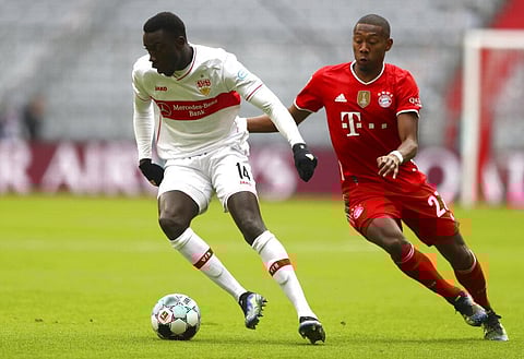 Stuttgart's Silas Wamangituka, left, and Bayern's David Alaba, right, challenge for the ball during the German Bundesliga soccer match. (Photo | AP)