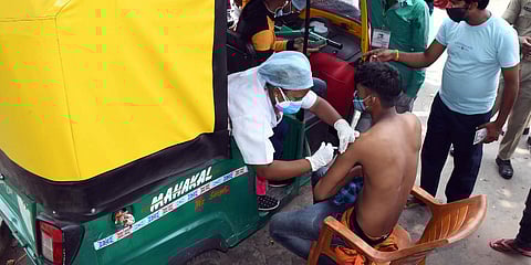 A medic inoculates the dose of COVID-19 vaccine to an auto-rickshaw driver in Ranchi. (File photo| ANI)