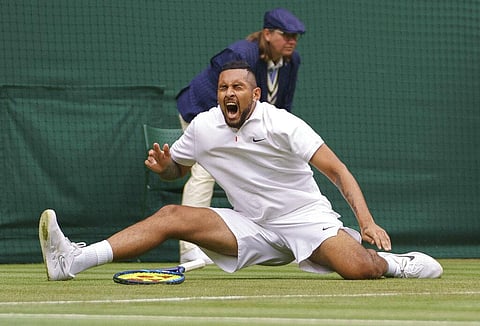 Australia's Nick Kyrgios slips after playing a return to Ugo Humbert of France during the men's singles first round match on day three of the Wimbledon Tennis Championships.