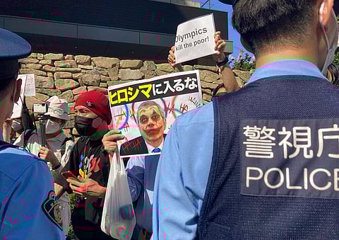 Protesters against the Olympic and Paralympic Games (Tokyo 2020) confront police officers in Tokyo. (Photo | AP)