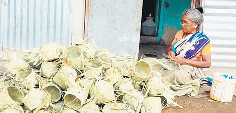 A woman from Nagalapuram making boxes with palmyra leaves | Express