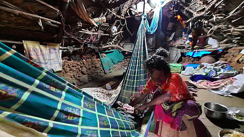 A woman with a baby inside her crumbling mud hut at an Irular hamlet in Pazhaveli village in Chengalpet. (Photo | Ashwin Prasath, EPS)