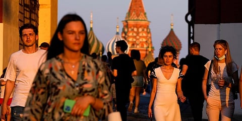 People, most of them without face masks, walk at Red Square during sunset in Moscow, Russia. (File Photo | AP)