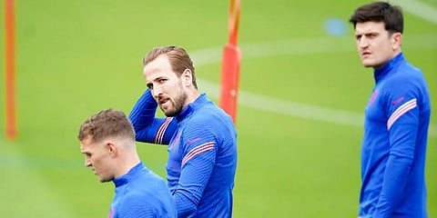 England's Harry Kane (C) and Harry Maguire (R) arrive for a training session at St George's Park. (Photo | AP)