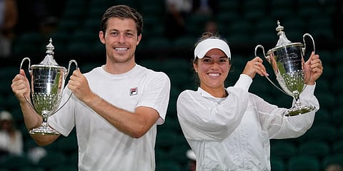 Desirae Krawczyk and Neal Skupiski celebrate with their winners trophies after they defeat Harriet Dart and Joe Salisbury, in the Wimbledon mixed doubles final in London. (Photo | AP)