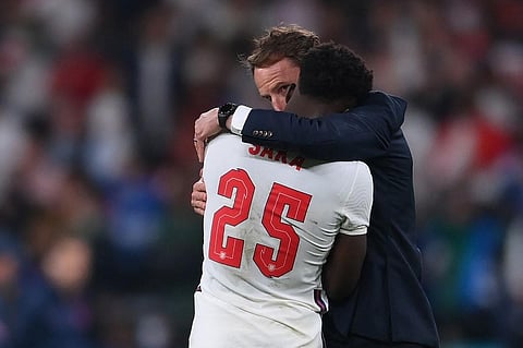 England's coach Gareth Southgate speaks to midfielder Bukayo Saka after their loss in EURO 2020 final against Italy at Wembley Stadium in London on July 11, 2021. (Photo | AFP)
