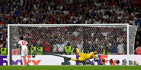 Italy's goalkeeper Gianluigi Donnarumma makes a save against England's Jadon Sancho during penalty shootout of the Euro 2020 final at Wembley Stadium, London on Sunday, July 11, 2021. (Photo | AP)