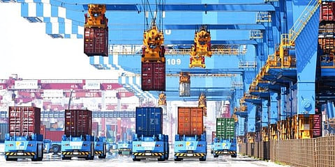 Gantry cranes move containers onto transporters at a port in Qingdao in eastern China's Shandong province. (Photo | AP)