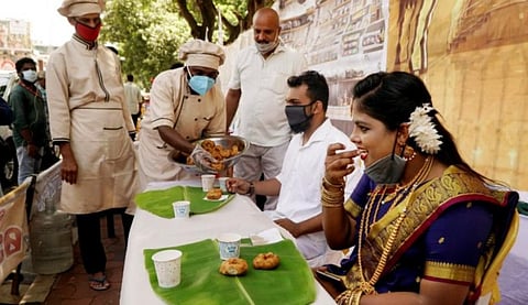 All Kerala Caterers Association serves a symbolic 'Sadya' in front of the Secretariat, during a protest demanding the state government to permit catering services. (Photo | PTI)