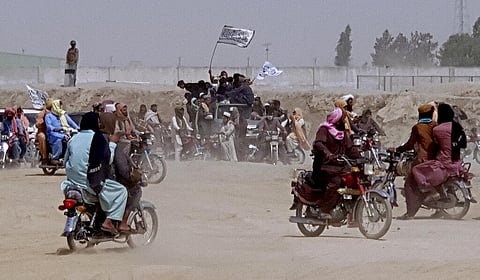 Supporters of the Taliban carry the Taliban's signature white flags in the Afghan-Pakistan border town of Chaman, Pakistan (Photo | AP)