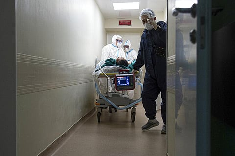 Medics wearing special suits to protect against coronavirus transport a patient with coronavirus at the City hospital No. 52 for coronavirus patients in Moscow. (Photo | AP)