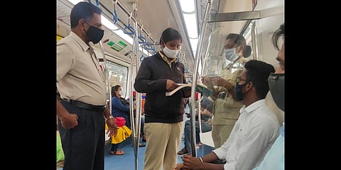 Security personnel penalise commuters for not wearing mask properly inside the train on Wednesday | Express