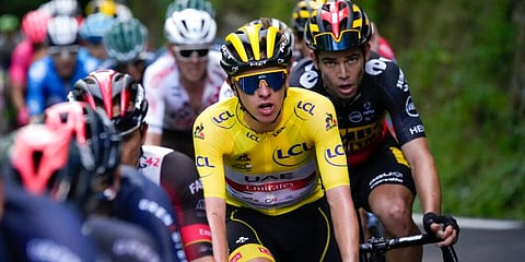 Slovenia's Tadej Pogacar, wearing the overall leader's yellow jersey, climbs during the eighteenth stage of the Tour de France cycling race over 129.7 kilometers, July 15, 2021. (Photo | AP)