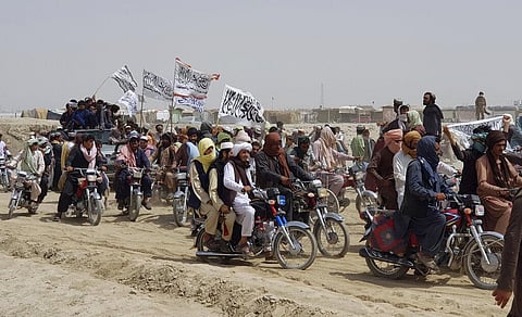 Supporters of the Taliban carry the Taliban's signature white flags in the Afghan-Pakistan border town. (Photo | AP)
