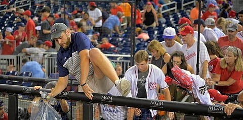 Fans pour out onto the field after hearing gunfire from outside the stadium, during a baseball game between the San Diego Padres and the Washington Nationals in Washington. (Photo | AP)
