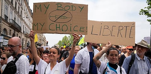 Nurses hold placards as they march during an anti-vaccine protest in Paris, Saturday, July 17, 2021. (Photo | AP)