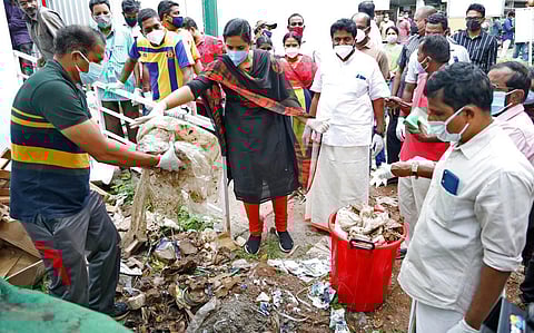 Mayor Arya Rajendran gives trash to the treatment facility inaugurated at the corporation office. (Photo | EPS)