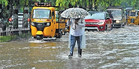 An old man walks with an umbrella as heavy rains lash Hyderabad on Sunday, July 18, 2021. (Photo | R V K Rao, Express)
