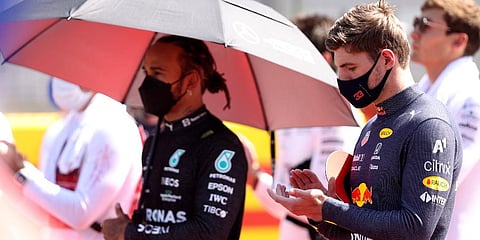 Red Bull driver Max Verstappen (R) and Mercedes driver Lewis Hamilton stand on the grid before the start of the British Formula One Grand Prix, at the Silverstone circuit. (Photo | AP)