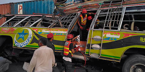 Rescue workers at the site of a deadly bus accident near Dera Ghazi Khan, Pakistan. (Photo| AP)