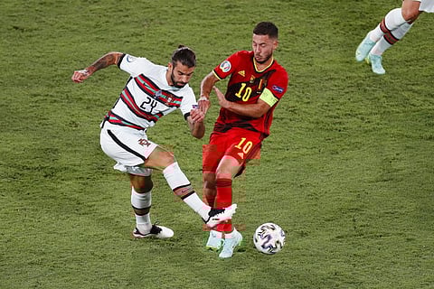 Portugal's Sergio Oliveira, left, competes for the ball with Belgium's Eden Hazard during the Euro 2020 soccer championship. (Photo | AP)