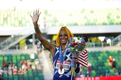 Sha'Carri Richardson waves after winning the women's 100-meter run at the U.S. Olympic Track and Field Trials. (Photo | AP)