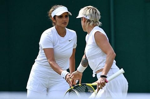 India's Sania Mirza (L) reacts during her women's doubles first round match with on the fourth day of the 2021 Wimbledon Championships. (Photo | AFP)