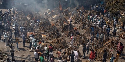 In this April 24, 2021, file photo, multiple funeral pyres of those who died of COVID-19 burn at a ground that has been converted into a crematorium for the mass cremation of coronavirus victims. (AP)