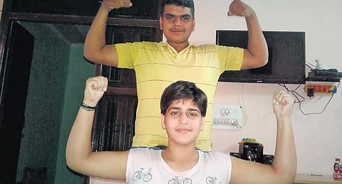 Lakra’s brother helps her exercise daily.