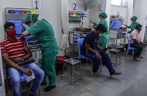 A health worker inoculates a man against COVID-19 at vaccination center in Mumbai. (Photo | AP)