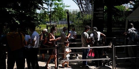 Visitors present COVID-19 tests at the entrance of the Eiffel Tower in Paris. (Photo| AP)