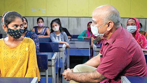 Deputy CM Manish Sisodia interacts with a student during PTA meet on Tuesday
