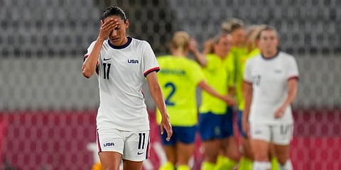 United States' Christen Press reacts as Sweden's players celebrate their third goal during a women's soccer match at the 2020 Summer Olympics, Wednesday, July 21, 2021, in Tokyo. (Photo | AP)