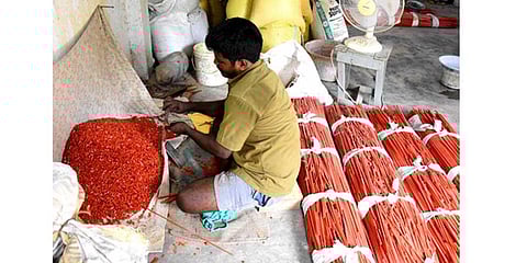 A worker produces colourful beads with glass stone at Papanaidupet village in Chittoor district | EXPRESS