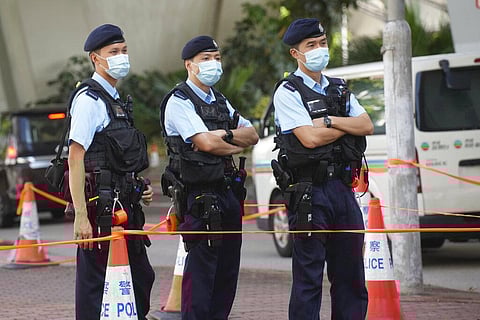Police officers stand guard outside local court in Hong Kong Thursday, July 22, 2021. (Photo | AP)